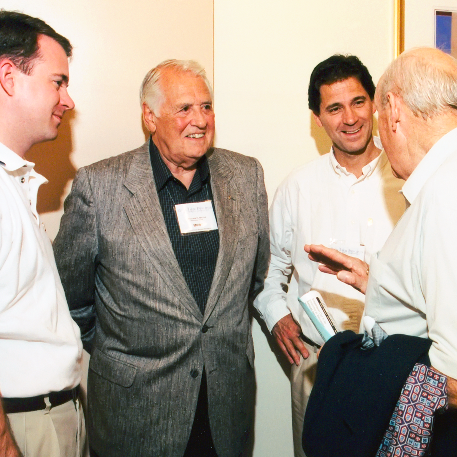 Bert Bates (second from left) speaks with Beta brothers at a Convention.