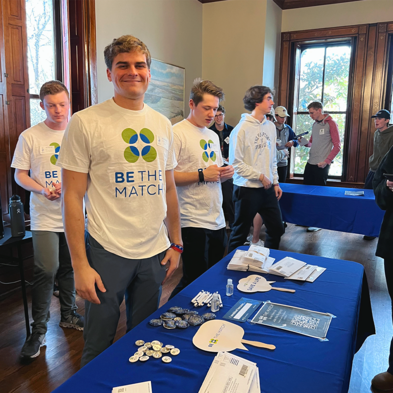 Adam Jolles, Kansas '24, stands at a table during the chapter's Be The Match event at the chapter house.