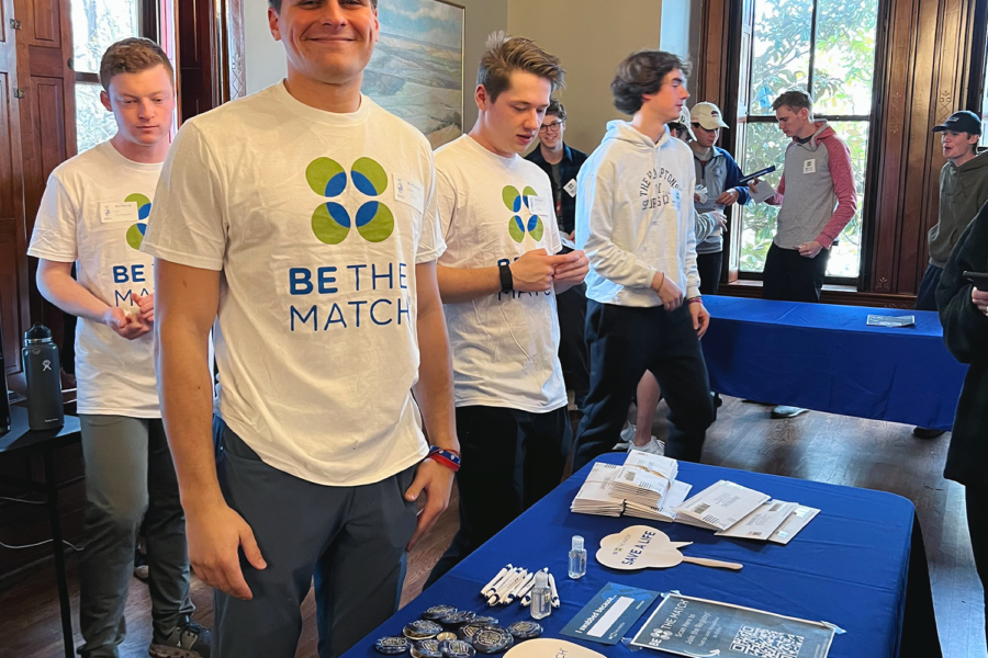 Adam Jolles, Kansas '24, stands at a table during the chapter's Be The Match event at the chapter house.