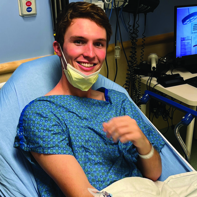 Luke Karel, Kansas '26, sits in a hospital bed in preparation of his chemotherapy treatment.