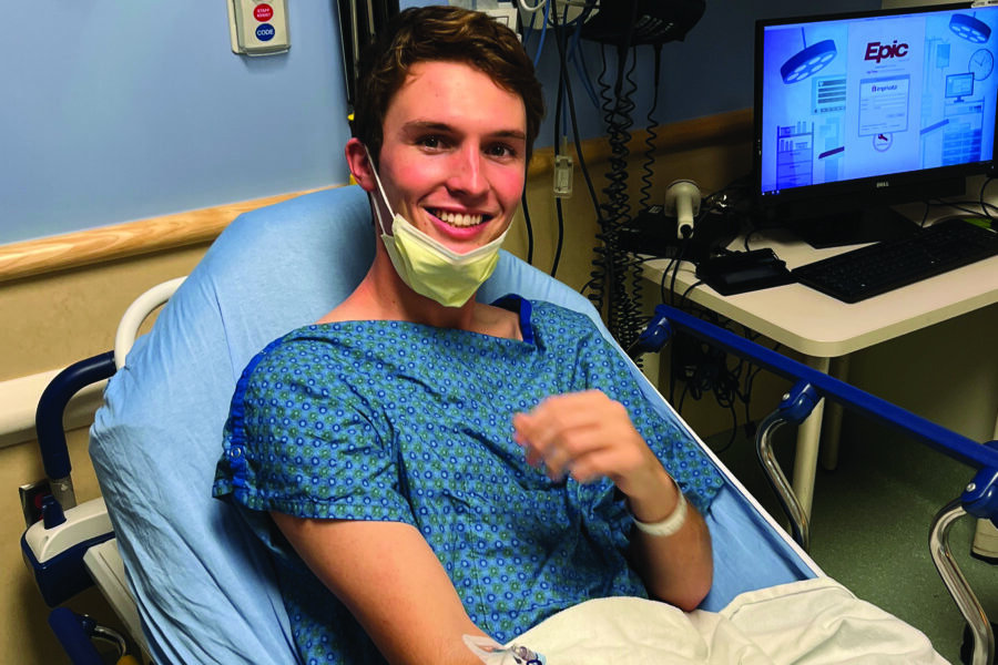 Luke Karel, Kansas '26, sits in a hospital bed in preparation of his chemotherapy treatment.