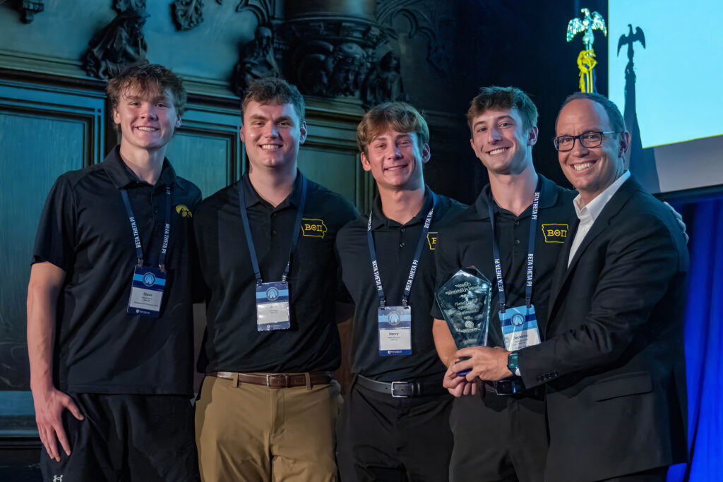 North American Interfraternity Conference CEO Judd Horras, Iowa State ’97, (far right) presents the NIC Chapter of Distinction Award to four members of the Iowa chapter.
