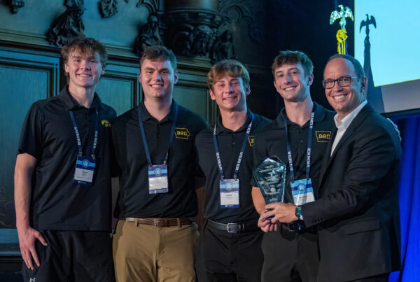 North American Interfraternity Conference CEO Judd Horras, Iowa State ’97, (far right) presents the NIC Chapter of Distinction Award to four members of the Iowa chapter.