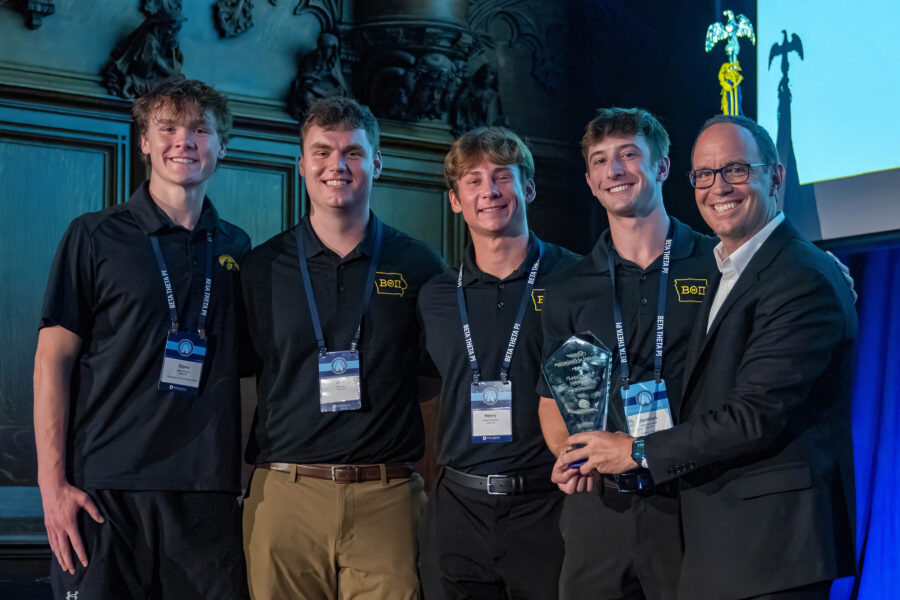 North American Interfraternity Conference CEO Judd Horras, Iowa State ’97, (far right) presents the NIC Chapter of Distinction Award to four members of the Iowa chapter.